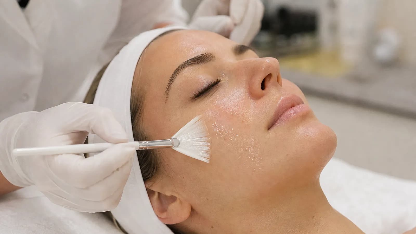 Chemical peel solution applied with a brush during a facial treatment